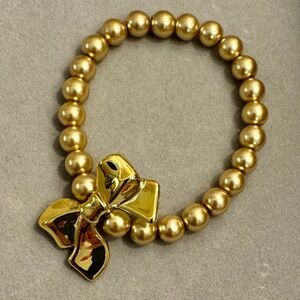 Hand Crafted Gold Bead Stretch Bracelet with Bow Charm
